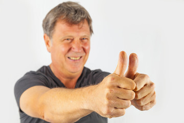 attractive man shows double thumbs up