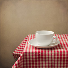 Background woth coffee cup on tablecloth