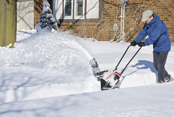 Man Using Snowblower to Clear Snow