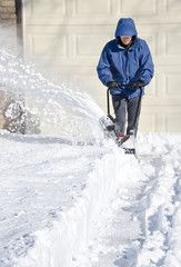Man Using Snowblower to Clear Snow