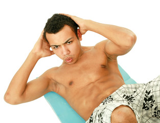 A young muscular man training, isolated on white background