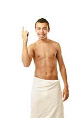Fototapeta premium A nude young man covering himself with a towel