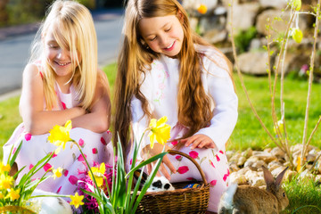 Children on Easter egg hunt with bunny