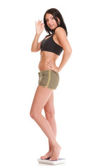 Naklejka premium Weight loss woman on scale happy ok sign