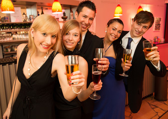 Group of five people standing in line celebrating