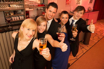 Group of five people standing in line celebrating