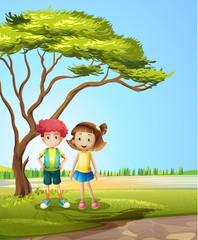 A girl and a boy near a big tree