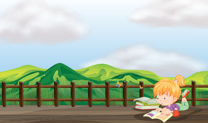 A girl studying at the wooden bridge