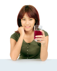 Isolated young asian woman with grapes juice over white.