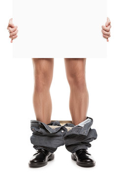 Man with pants down holding blank placard