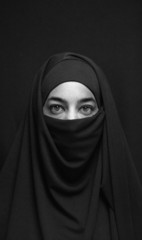 woman in burka over dark background