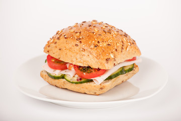 Mehrkorn Brötchen belegt mit Schinken und Salat auf Teller