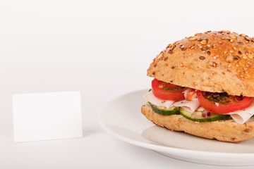 Mehrkorn Brötchen belegt mit Schinken u Salat mit Hinweisschild