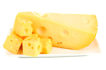Cut cheese on plate isolated on white