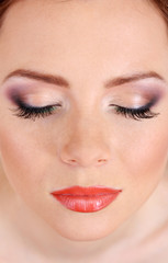 Naklejka premium Beautiful female face with bright make-up, close up