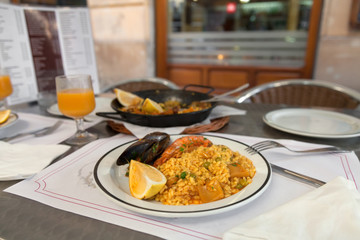 Paella on the plate in street cafe