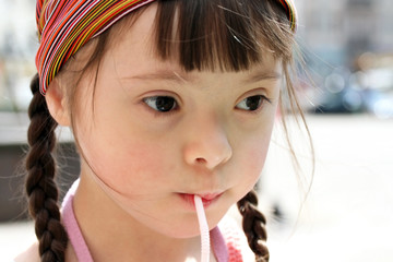 Portrait of little girl drinking water