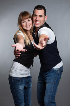 Beautiful young couple man and woman in love. Studio.