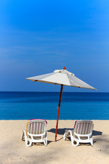 beds and umbrella on a beach