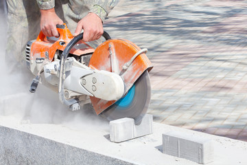 Cutting and grinding concrete or metal using a cut off saw