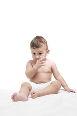 Baby sitting on a towel, bright background