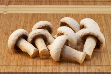 white champignons on a wooden board