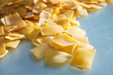 Raw, little square pasta on a glass plate