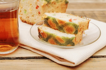 slice sweet bread with glass tea on wooden background
