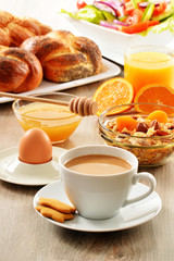 Breakfast including coffee, bread, honey, orange juice, muesli a