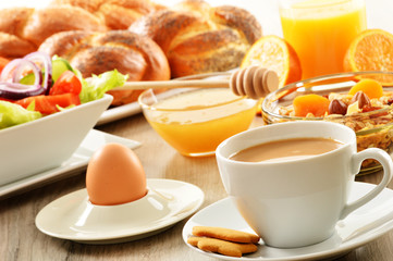 Breakfast including coffee, bread, honey, orange juice, muesli a