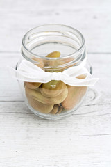 Beans in glass jar on wooden background