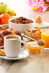 Breakfast including coffee, bread, honey, orange juice, muesli a