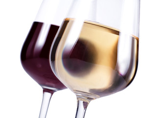 close up of two wine glasses with red and white wine