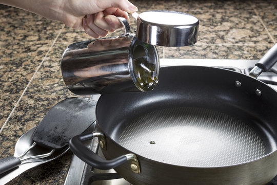 Adding cooking oil in frying pan