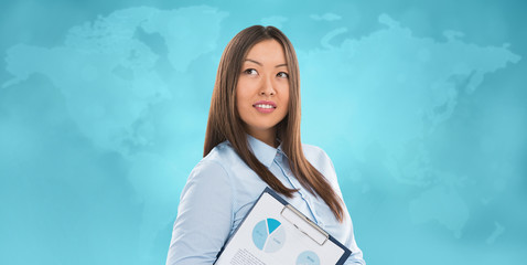 Asian business woman holding reports and smiling against world m
