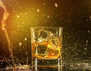 Whiskey splashing around glass