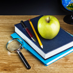 Teacher's desk with a notebook and other equipment.