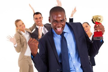excited african american businessman winning a trophy