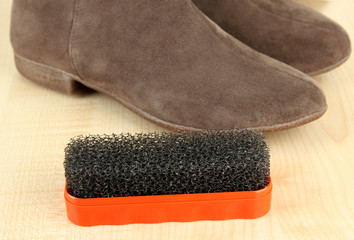 Brush for suede shoes, on wooden background