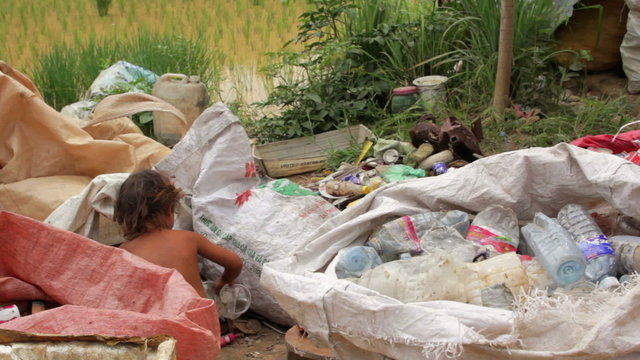 Garbage gatherers assorting trashes in slums