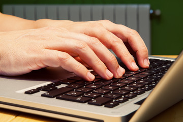 Man checking the heating bill on a laptop