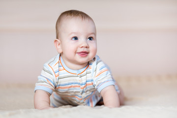 Fototapeta premium cute baby boy crawling indoors