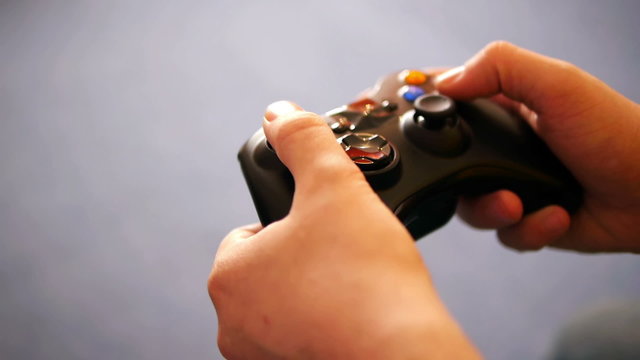 hands of an adult man playing video game close-up