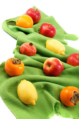 Set of different fresh fruits on green cloth.
