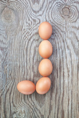 A letter j from the eggs for  easter. On a wooden texture.