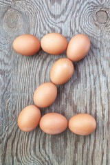 A letter z from the eggs for Easter. On a wooden texture.