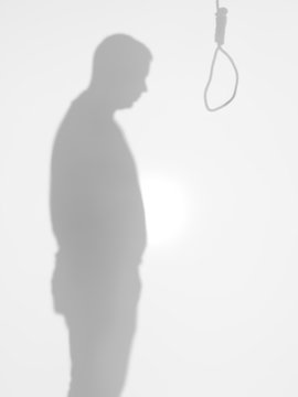 male silhouette standing in front of a hanging rope  suicide