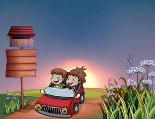 Kids in a car, notice board and a letter box