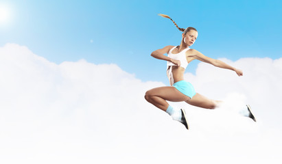 Fototapeta na wymiar Image of sport woman jumping