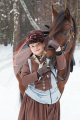 Fototapeta premium woman keeps the Arab racer in brown riding habit